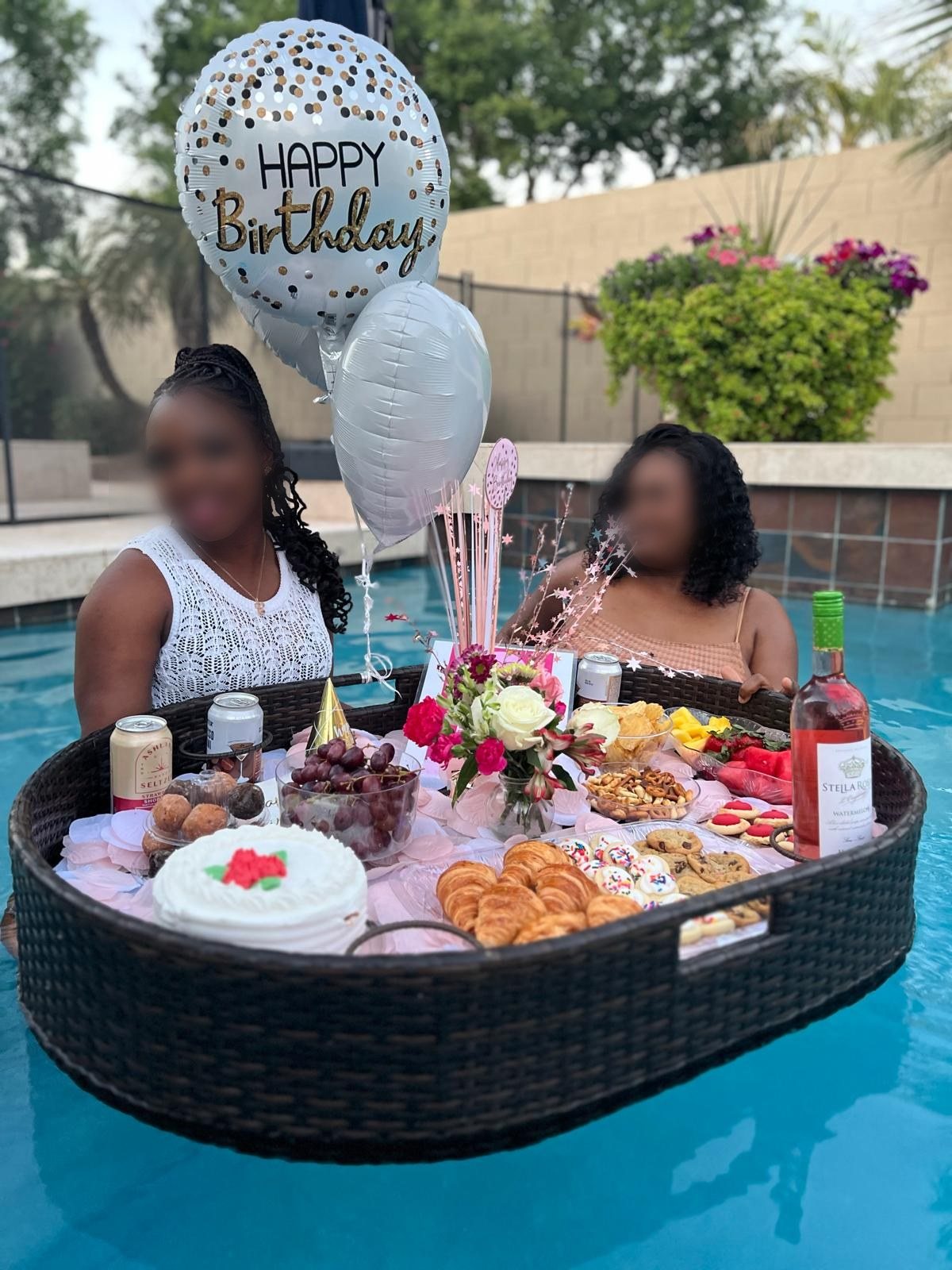 A styled floating brunch tray on a pool